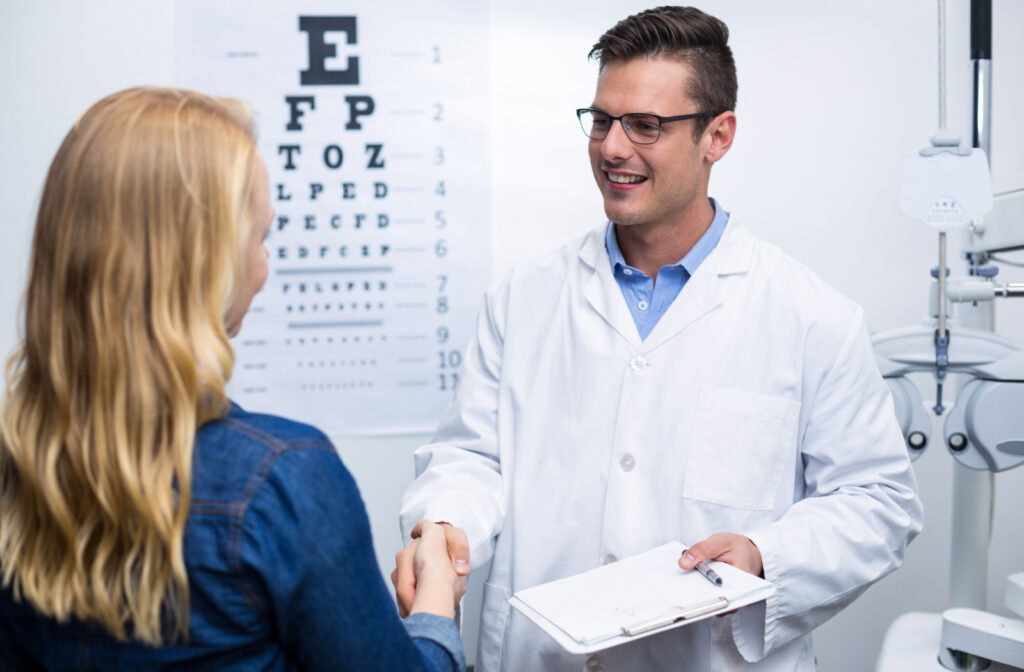 An optometrist shaking hands with a patient in an optometry clinic.