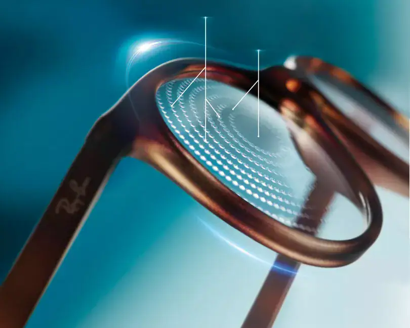 Photorealistic illustration of a pair of Ray Bans frames with Essilor Stellest lens showing the lenselets circular dot pattern.