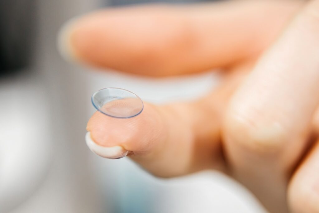 Close up image of a contact lens laying on a finger.